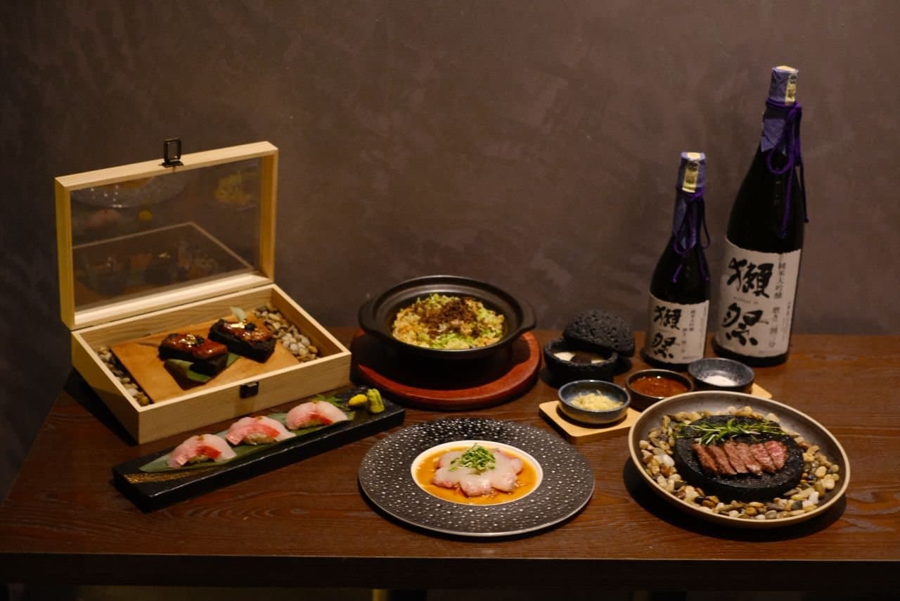 A spread with Dassai sake, a donabe and wagyu